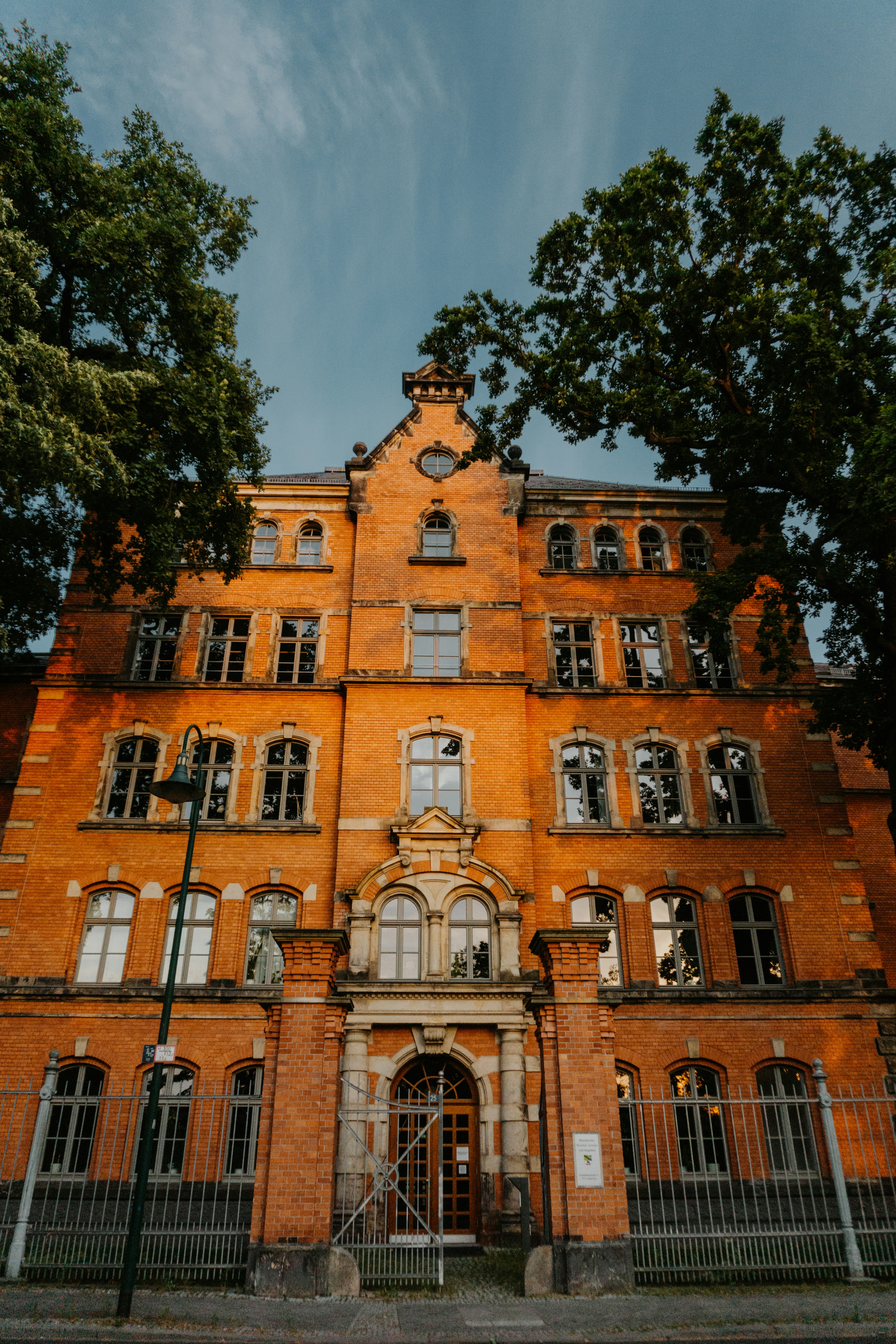 low-angle photography of red concrete building under blue sky